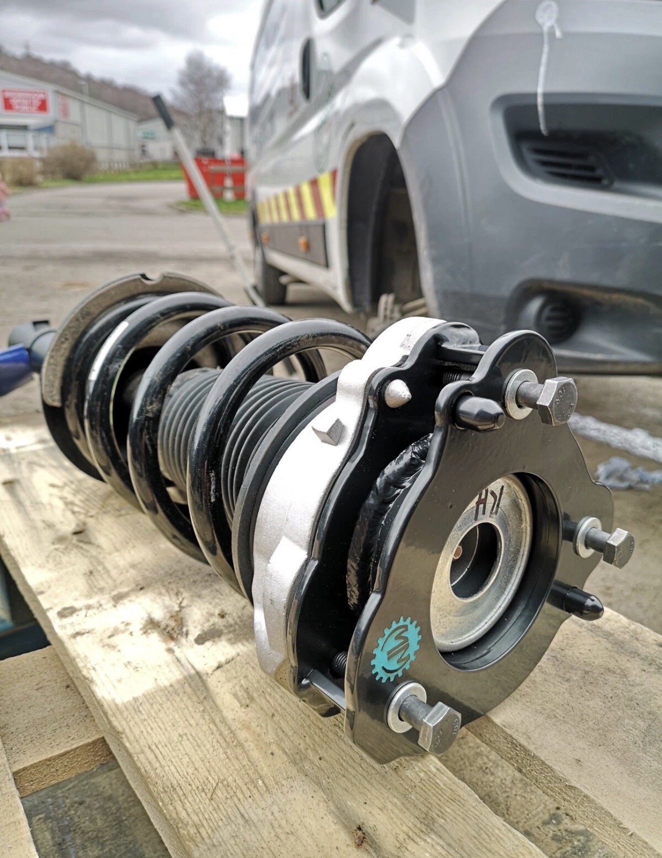 Assembled lift kit strut with coil spring and hub carrier ready to fit to a van